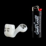 White glass pipe and black lighter with “Smoke Cartel” logo against a black background.