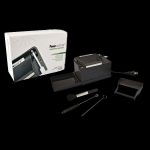 A slightly angled, top-down view of the Powermatic II+ Electric Cigarette Injector Machine on a dark surface, showing its black plastic casing and control buttons.