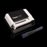 Powermatic cigarette rolling machine with cleaning brush.