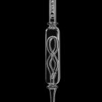 A studio shot of the Pulsar Quartz Internal Twist Perc Nectar Collector, angled to showcase its clear glass and twisted internal design.