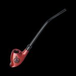 Red glass cannabis oil burner pipe with a skull and laurel wreath design, isolated on black.