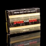 Stacked boxes of “Spark Your Bark” natural arabic gum slow-burning rolling paper, reflecting on a dark surface.