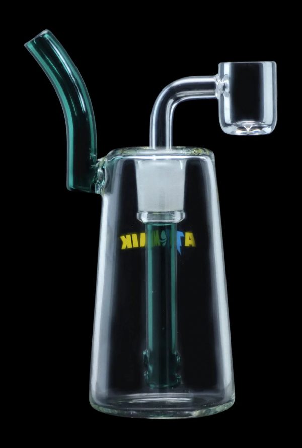 Clear glass dab rig with a bent neck and quartz banger, illuminated with green light.