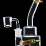 Glass oil rig with quartz banger, featuring an ""Atomik"" logo."