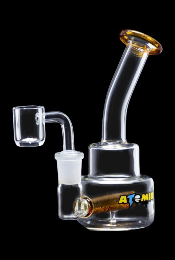 Glass oil rig with quartz banger, featuring an ""Atomik"" logo."
