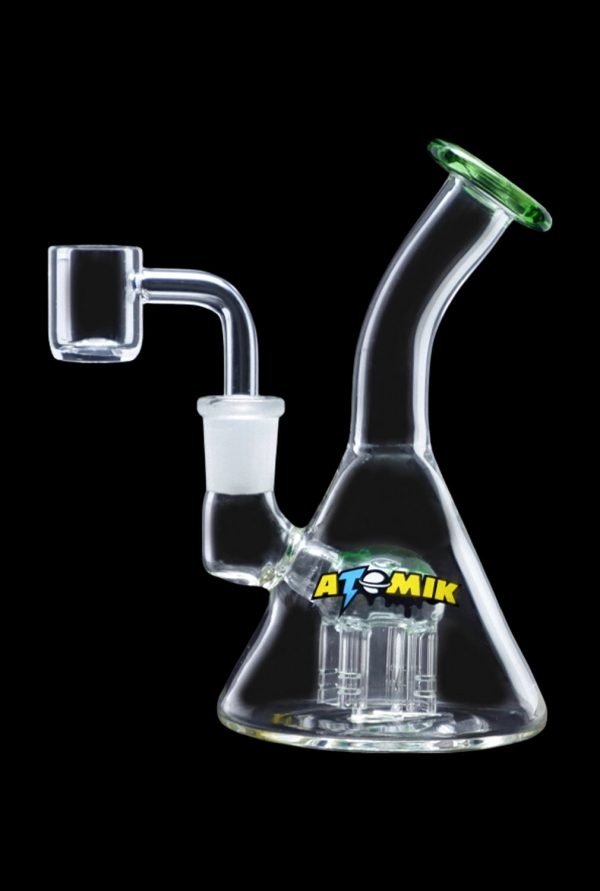 Clear glass dab rig with a quartz banger, featuring a percolator base and branded with "ATOMIK."