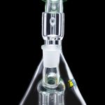 Clear glass water pipe (bong) with a complex percolator chamber, isolated on a black background.