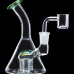 Clear glass water pipe (bong) with green accents and a quartz banger next to it, isolated on a black background.