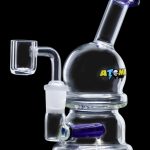 Clear glass dab rig with blue accents and a quartz banger, isolated on a black background.