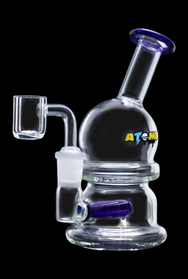 Clear glass dab rig with blue accents and a quartz banger, isolated on a black background.
