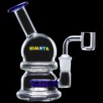 Glass water pipe (rig) with a quartz banger, isolated on a black background.