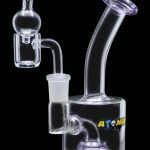 A side view of the Atomik Little Dipper Dab Rig showcases its compact size and clear glass construction with a visible joint.