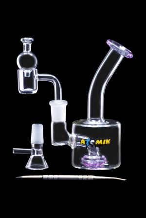 A side view of the Atomik Little Dipper Dab Rig, showcasing its clear glass construction and compact 5.25-inch size.