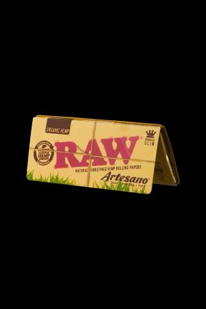 Pack of RAW Organic Hemp rolling papers and Artesano tips against a black background.