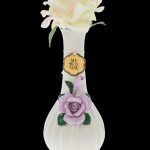 Elegant glass vase with sculpted floral details, marketed as a "Bud Vase" for cannabis use.