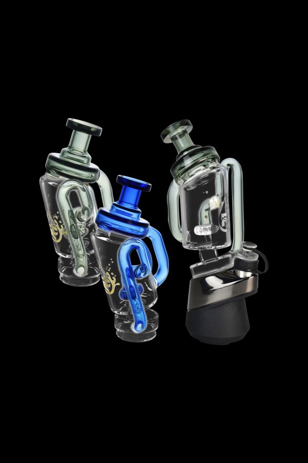 Two glass cannabis rigs with intricate designs, one featuring blue accents, against a black background.