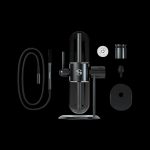 Black cannabis vaporizer device with disassembled components arranged around it on a black background.