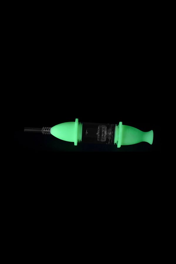 Glowing green dab syringe with glass tip and intricate internal structure.