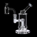 Clear glass dab rig with a quartz banger and carb cap, isolated on a black background.