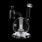 Clear glass dab rig with a bubbler and quartz nail, isolated on a black background.