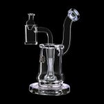 Clear glass dab rig with a quartz banger and intricate swirling design, isolated on a black background.