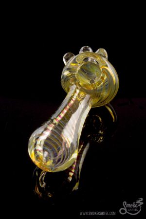 A detailed side view of the Gold Fumed Spoon Pipe - Midas, showcasing its curved shape and golden sheen against a black background.
