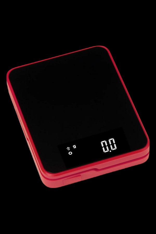 Red digital scale displaying 0.00 grams, used for measuring cannabis.