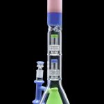 Blue and green glass bong with intricate percolators, displayed with a separate glass bowl.