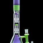 A vibrant green and purple glass bong with percolators, alongside a glass downstem and bowl piece.