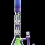 A colorful glass water pipe (bong) with a flared base, multiple filtration chambers, and accompanying glass pieces, isolated on a black background.