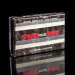 A pack of "Spark Your Bark" natural rice rolling papers with a woodgrain texture, set against a black background.