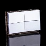 Stack of pre-rolled hemp filter tips with a mirrored reflection on a black surface.