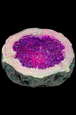 A top-down view of the Sparkling Geode Ashtray, showcasing a purple, crystalline interior within a circular dish.
