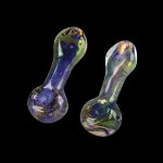 A close-up, angled view of the Spattered Fumed Hand Pipe, showcasing its colorful, glass construction against a dark background.