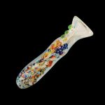 A detailed close-up of the Splatter Frit Glass Chillum Taster Pipe, showcasing its colorful frit pattern and slender design.