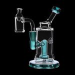 Clear glass dab rig with teal accents and accessories, studio shot on black background.