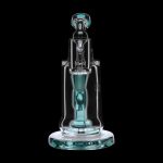 A turquoise glass rig with a bubbler and quartz insert, isolated on a black background.