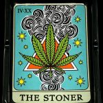 A close-up, top-down view of The Stoner Tarot Card Ashtray, depicting a colorful, illustrated tarot card design.