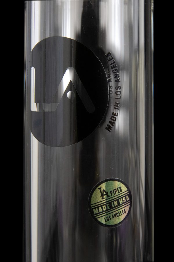 Close-up, angled view of the LA Pipes Mini Bubble Base Concentrate Rig with visible lettering on the glass surface.