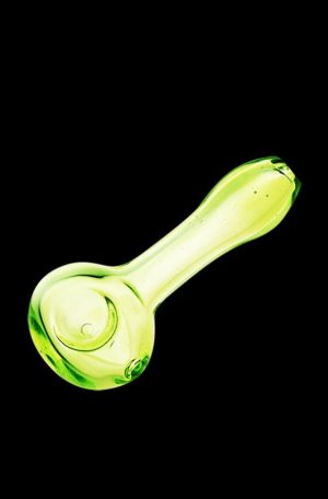 A side view of the translucent Spring Green Spoon Pipe, showing its curved shape and simple glass construction.