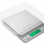 A close-up, top-down view of the Truweigh Enigma Digital Mini Scale with a sleek, silver finish and digital display.