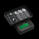 Close-up, angled view of the Truweigh Gauge Digital Mini Scale displaying a reading on its digital screen.
