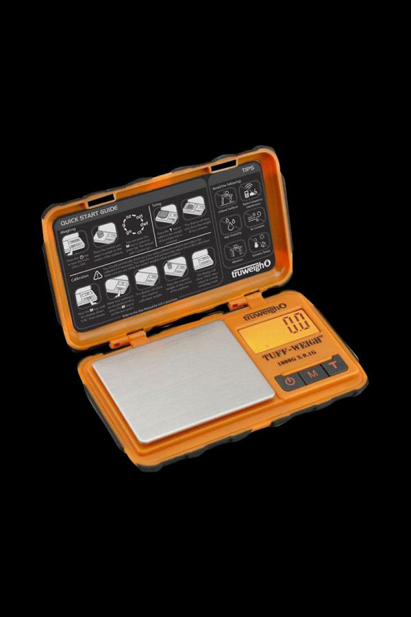 A top-down view of the open Truweigh Tuff-Weigh Mini Scale, displaying a quick start guide and calibration instructions.