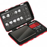 A top-down view of the open Truweigh Tuff-Weigh Mini Scale, displaying its internal components and instructional guide.