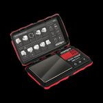 A top-down view of the Truweigh Tuff-Weigh Mini Scale, showcasing its digital display and open lid on a dark surface.