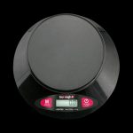 A close-up, angled view of the Truweigh Vortex Digital Bowl Scale, displaying a digital readout on its black surface.