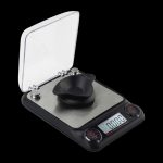 Close-up of the Truweigh Xeno Digital Milligram Scale displaying a digital readout on its black platform.