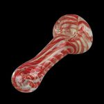 Red and white swirled glass pipe against a black background.