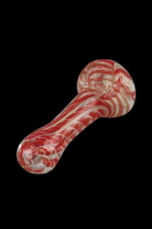 Red and white swirled glass pipe against a black background.