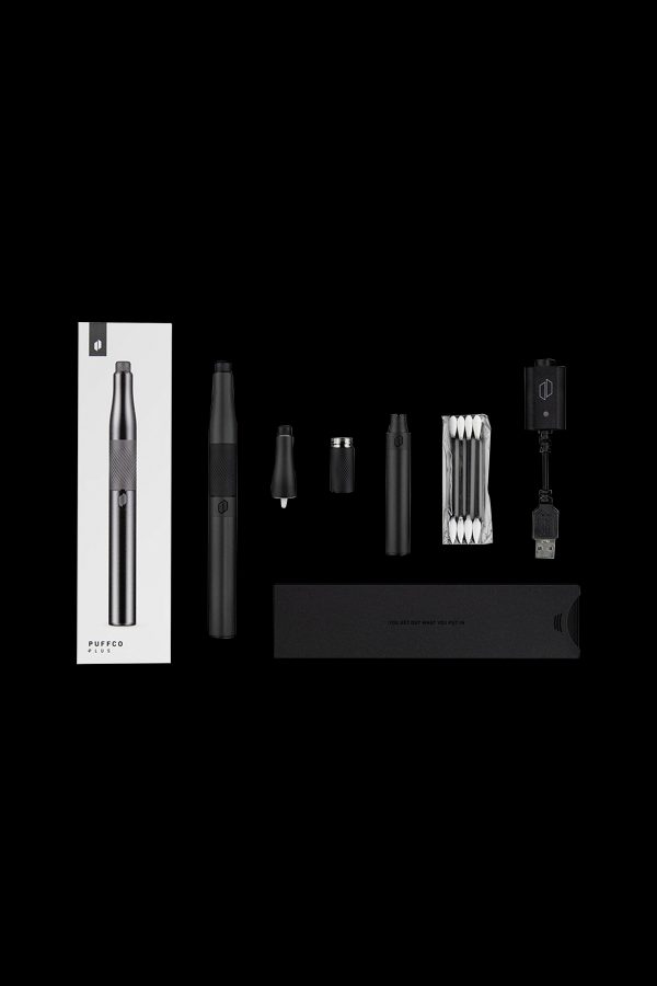 Puffco Plus vaporizing pen kit laid out with device, battery, atomizer, quartz crystal, USB charger, and packaging.